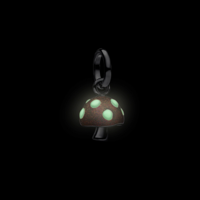 Mushroom-shaped pendant with glowing green spots on a black background
