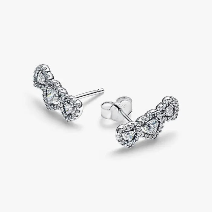 Pandora Halo Heart Trilogy Stud Earrings with heart-shaped stones and pavé halo in sterling silver.