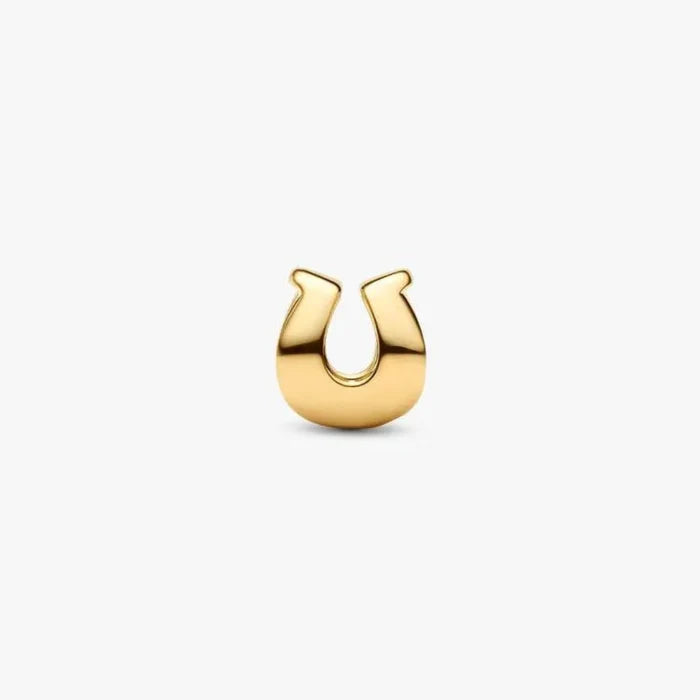 Gold horseshoe-shaped earring on a white background