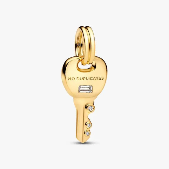 Gold key-shaped pendant with 'No Duplicates' engraving on a white background