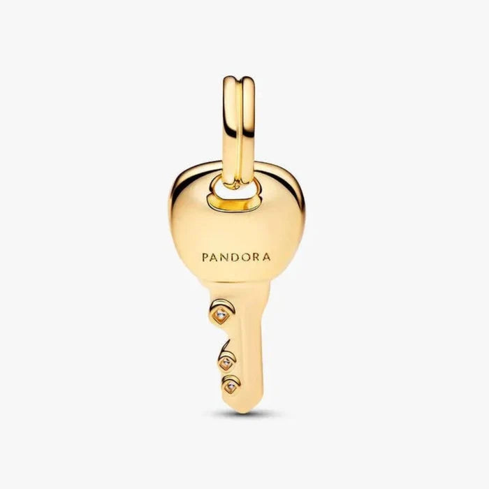 Gold key-shaped pendant with 'Pandora' branding on a white background