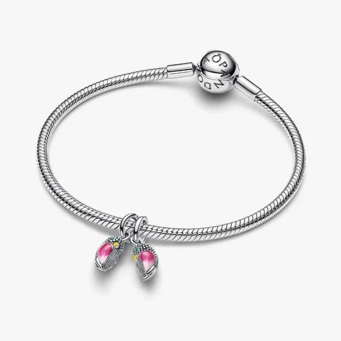 Silver bird-shaped charm on a light background