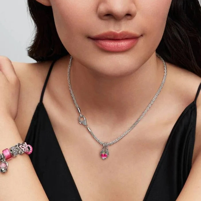 Silver bracelet and necklace with a bird-shaped charm on a women