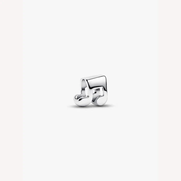 Silver music note charm on a light background