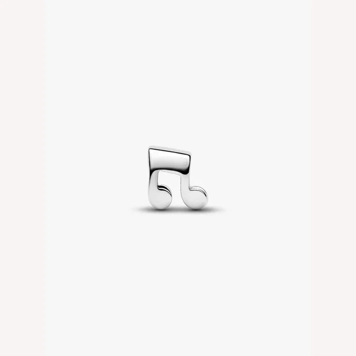 Silver music note charm on a light background