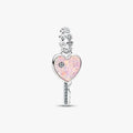 Heart-shaped key charm with pink opal and clear gemstones on a white background
