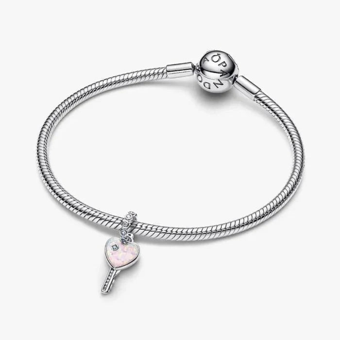 Silver bracelet with a heart-shaped charm on a white background