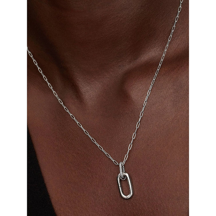 Close-up of Pandora silver oval link pendant necklace on chain, worn with black top.