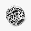 A silver ring featuring an intricate black and white design, showcasing a modern and elegant aesthetic.