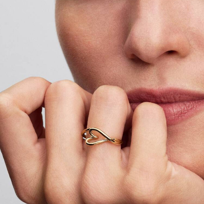 Pandora Organically Shaped Heart Small Ring in gold tone worn on a woman's finger.