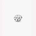Silver peace symbol charm on a light background