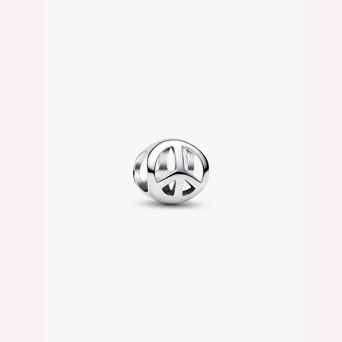 Silver peace symbol charm on a light background