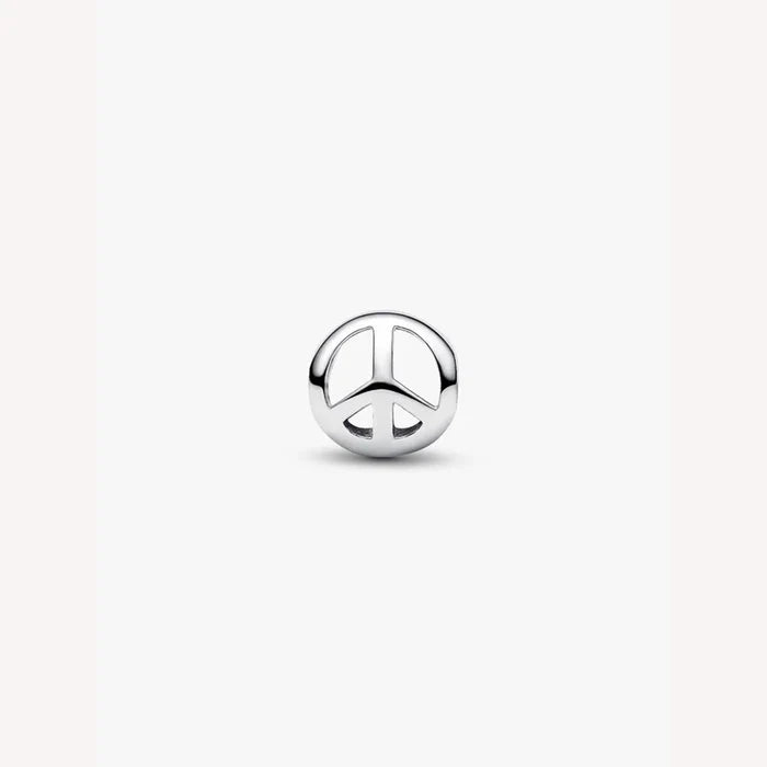 Silver peace symbol charm on a light background