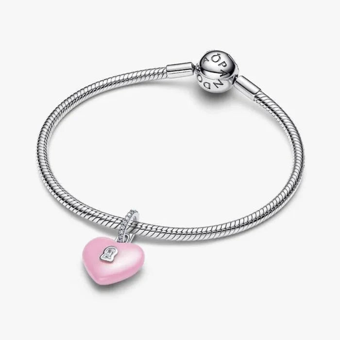 Silver bracelet with a pink heart-shaped charm on a white background