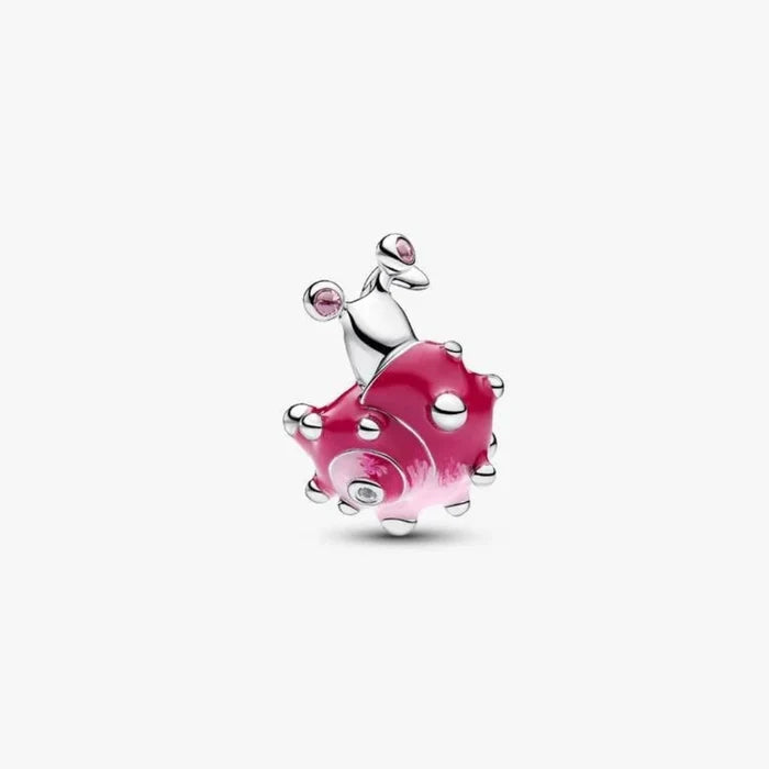 Silver charm with pink glass on a white background