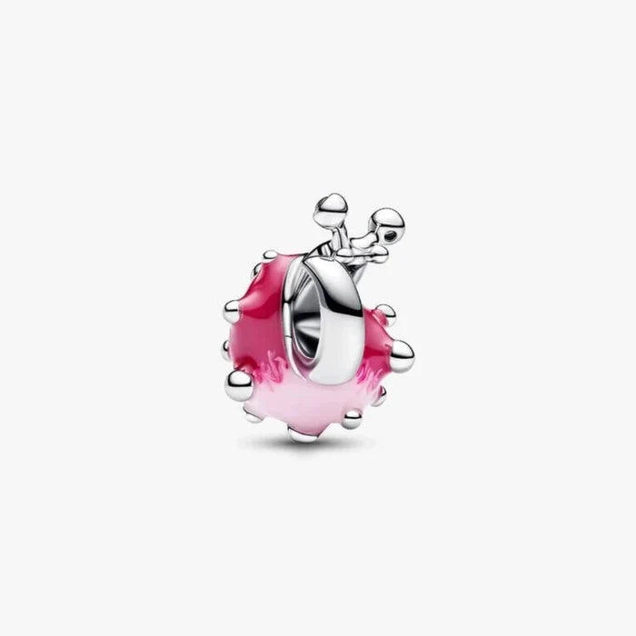 Silver charm with pink glass on a white background