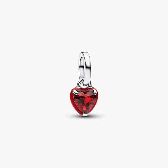 Silver pendant with a red heart-shaped gemstone on a white background
