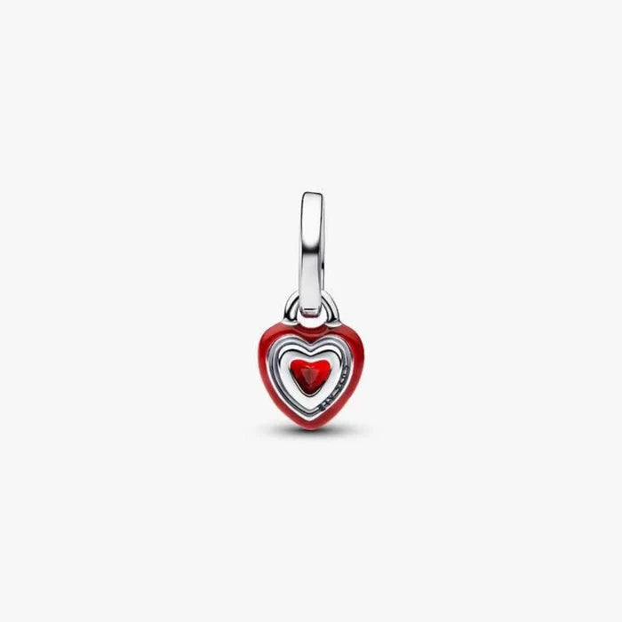 Heart-shaped pendant with red center on a white background