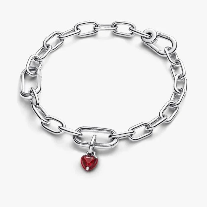 Silver chain bracelet with a red heart charm on a white background