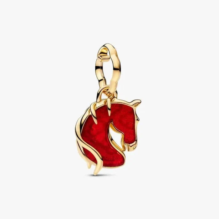 Gold pendant with a red enameled horse design on a white background