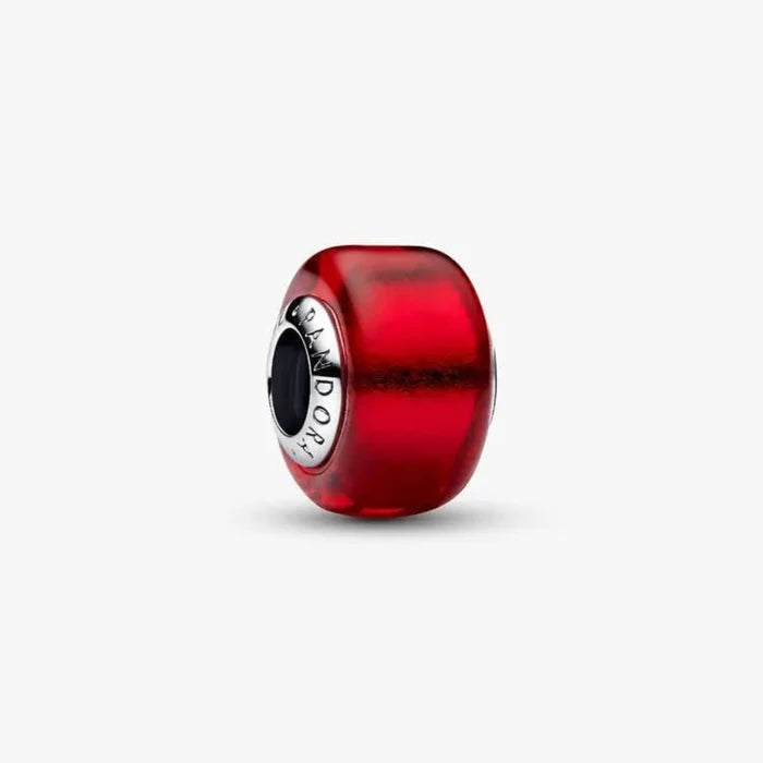 Red glass charm with silver clasp on a white background