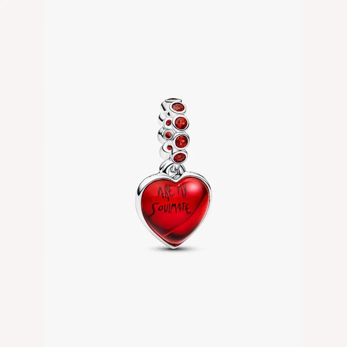 Heart-shaped pendant with red stone accents on a light background