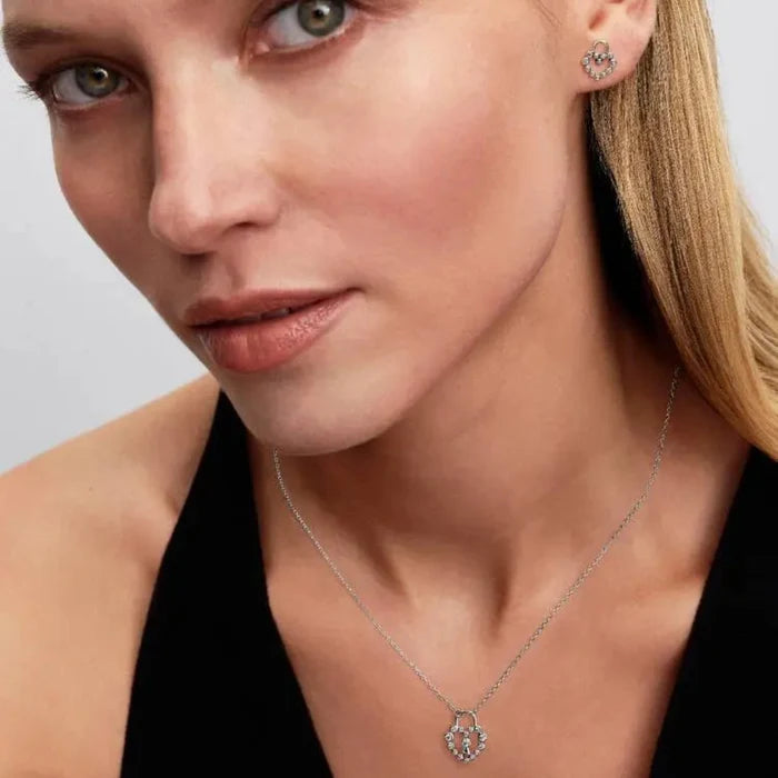 Pandora Heart Padlock Stud Earrings worn by a woman with a matching necklace.