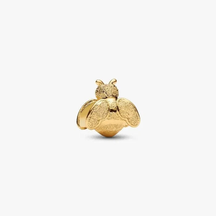 Gold bee-shaped jewelry charm on a white background