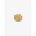 A close-up of a textured gold-plated four-leaf clover charm with sparkling detail.