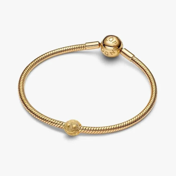 Gold bracelet with a rope design on a white background