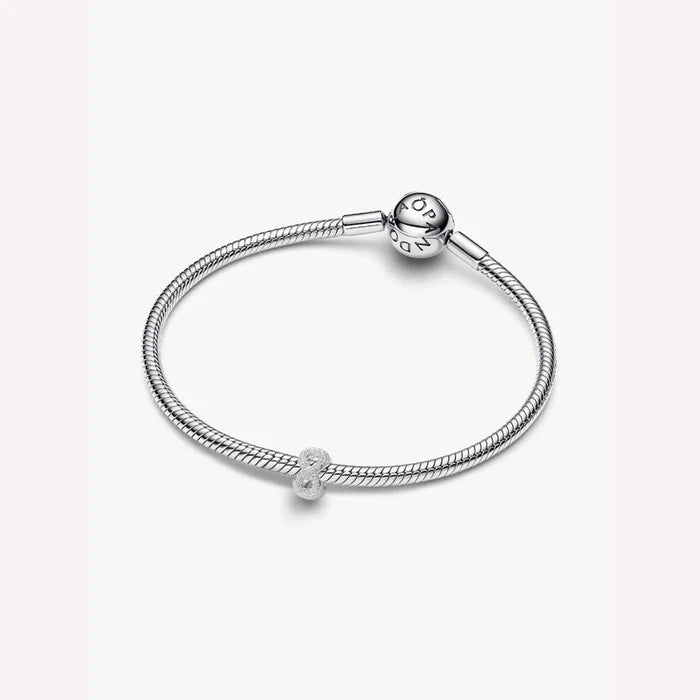 Silver bracelet with a round charm on a white background