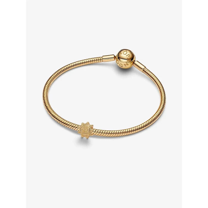 Gold sun charm styled on a Pandora Moments snake chain bracelet.