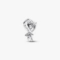 Silver tulip shaped charm on a light background
