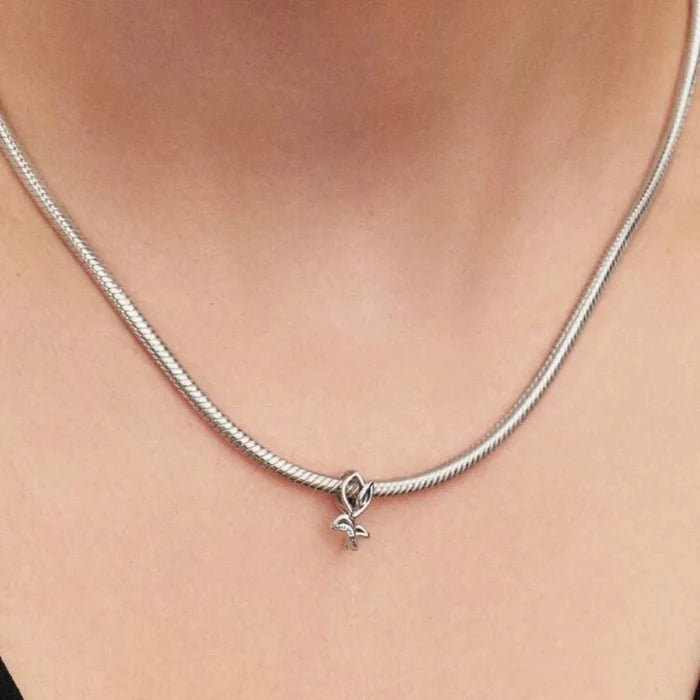 Silver necklace with a tulip-shaped charm on a women