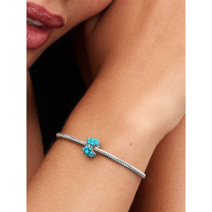 Model wearing the Pandora Turquoise-colored Ocean Charm on a silver bracelet
