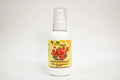Bottle of organic pomegranate oil with a yellow label on a white background