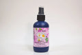 Bottle of organic chamomile Roman hydrosol with a spray nozzle on a white background