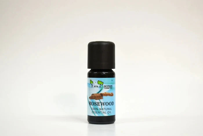 Bottle of rosewood essential oil on a white background