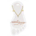 Gold anklet on a white display card with 'sand & stone' branding.