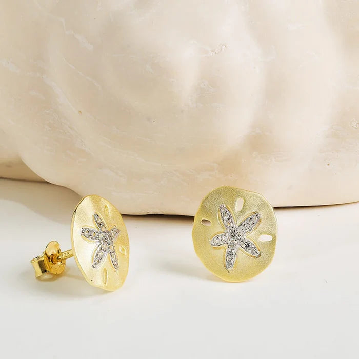 Shanore : 14kt Gold Vermeil White Sapphire Sand Dollar Earrings displayed near shell