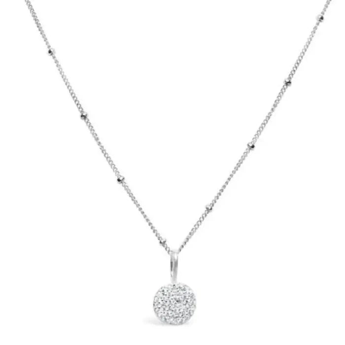 This elegant piece features a delicate round pavé disk pendant, encrusted with shimmering crystals for a subtle yet eye-catching finish.