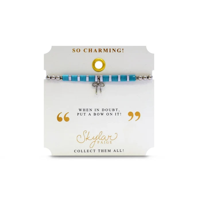 A vibrant turquoise bracelet featuring a charming bow, adding a touch of elegance to the accessory.
