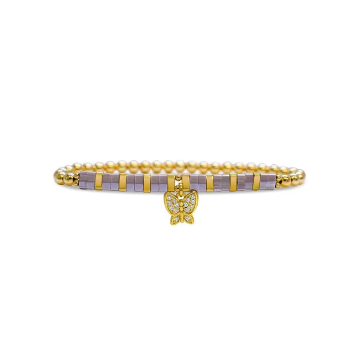 A gold bracelet featuring a delicate small diamond charm, elegantly designed for a sophisticated look.