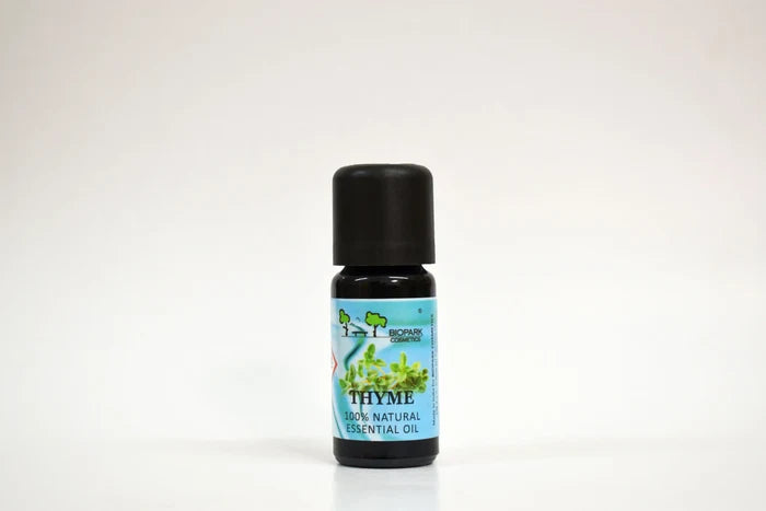 Bottle of thyme essential oil on a white background