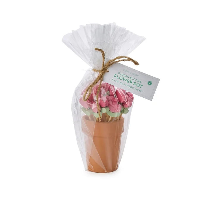 Two decorative flower pots filled with various sticks of flowers, adding a touch of nature to the setting.