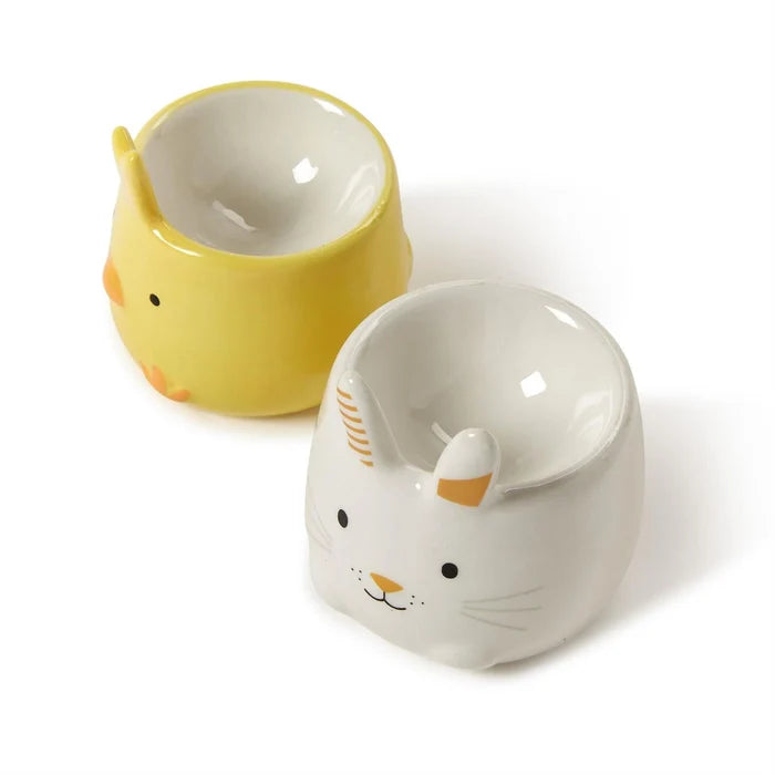 A pair of ceramic cups adorned with charming bunny and rabbit faces, ideal for adding a playful touch to your drinkware.