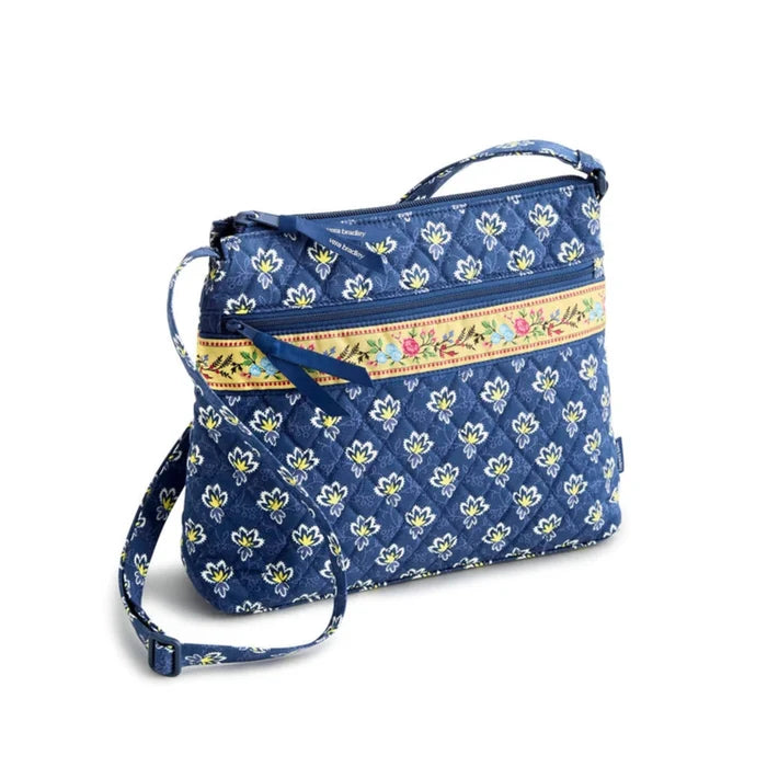 Blue floral print crossbody bag made from soft fabric, featuring a stylish and functional design for everyday use.