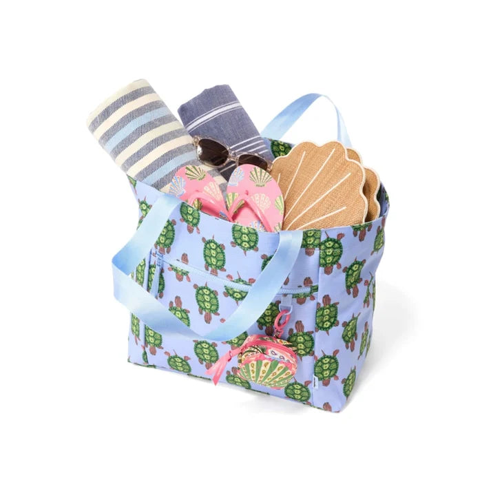 A blue turtle print tote bag with a coordinating blue handle for easy carrying.