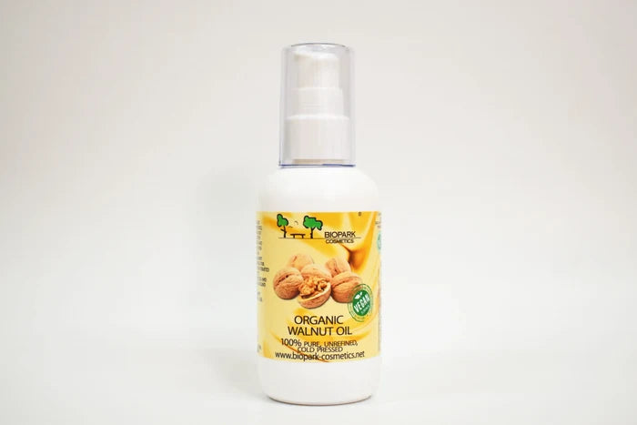 Bottle of organic walnut oil with a yellow label on a white background