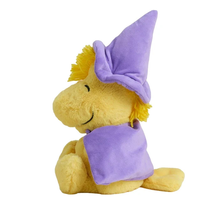 Plush toy resembling a yellow creature with a purple hat and cape on a white background
